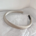 Detail of beige satin headband with silky texture and handmade label on white paper - Silver Grey
