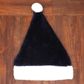 Flat lay detail of navy blue plush Christmas hat on a rustic wooden floor background - Navy Blue