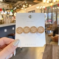 Handheld gold hair clip featuring four champagne round crystals on a white card display - Gold Four Crystal Bobby Pin / Champagne