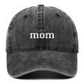 Close-up of white 'mom' embroidery on a washed charcoal grey cotton baseball cap - MOM / Black