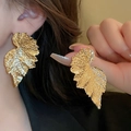 Elegant gold leaf earrings with textured metal veins worn by a fashion model - Gold Realistic Leaf Stud Earrings (24#)