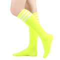 Detail of neon yellow over-the-knee socks with white triple stripes on a model - One Size / Neon Yellow with White Stripes