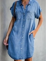 Detailed view of light blue denim shirt dress featuring chest pockets and button closure - S / Light Blue