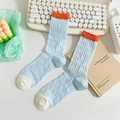 Light blue mid-calf sock with orange cuffs and beige accents on a clean lifestyle background - One Size / Multicolor Light Blue (Orange Cuff/Beige Toe)