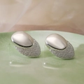 Silver geometric oval earrings with dual polished and frosted texture on a green plate - Matte Polished Stitching Oval / Silver