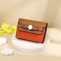 Detail of brown and orange leather card wallet with lychee texture and silver buckle - Orange