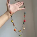 Detail of colorful ceramic beads with hand-painted patterns on a brown woven necklace cord - Brown Colorful Beads (17# Necklace)