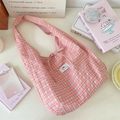 Close-up view of a stylish pink and white plaid tote bag with a tie-front detail - Watermelon red