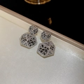Macro shot of silver floral hollow hexagonal earrings with vintage granulation texture - Silver Hollow Flower Style (S925 Sterling Silver Pin)