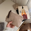 Close-up of herringbone tweed mini pouch with multicolored flecks and braided zipper pull - Khaki