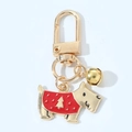 Detail of dog keychain with gold bell and Christmas sweater charm on D-ring - Schnauzer With Bell