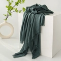 Deep green cotton linen scarf with fringe edges and soft wrinkled texture on white stand - Dark Green