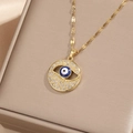 Close-up of golden Evil Eye pendant with cubic zirconia inlay in a jewelry box - Gold White Zircon-Circular Hollow