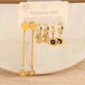 Detailed macro view of three pairs of gold stainless steel stud earrings on a display card - Snake Chain Evil Eye 3-Piece Set (9#)