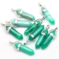 Macro shot of green quartz hexagonal prism pendants with metallic bail attachments - Green Agate
