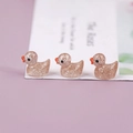 Macro shot of mini resin ducks with champagne pink glitter finish for DIY crafts - Gold