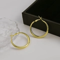 Minimalistische polierte goldene Creolen für Damen auf einem eleganten Schmuckdisplay - Kleine Größe / Gold