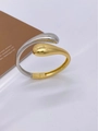 Detailed side view of a bicolor teardrop open bangle with gold and silver polished finish - Cuff Bracelet / Gold and Silver Two-tone