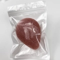Biodegradable reddish-brown konjac facial cleansing sponge in a clear poly bag - Red Clay Teardrop
