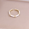Detail view of bamboo-style gold ring with white enamel accents and small rhinestones - Adjustable Open / White