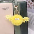 Yellow faux mink fur bat keychain charm with laser wings on a stylish handbag handle - Gold Chain / Yellow