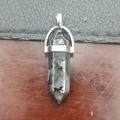 Hexagonal grey quartz point pendant necklace with silver clasp on a wooden surface - Picasso Jasper