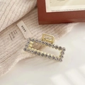 Detail of elegant gold metal hair claw clip with pavé white rhinestones in rectangular shape - Rectangle Metal Style (F-011)