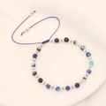 Handmade bohemian beaded bracelet with natural blue stones and gold spacers on white background - Sapphire Blue
