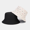 Close-up of black and cream canvas bucket hats featuring a red and black anchor print pattern - M (56-58cm) / Beige