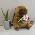 Cute brown plush Capybara backpack for children featuring a decorative pink flower accessory - Capybara Pink Flower Style / 35cm
