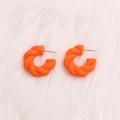 Exaggerated orange twisted C-shape acrylic hoop earrings with matte finish on faux fur - Orange Twisted