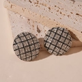 Close-up of vintage geometric round stud earrings with shimmering rhinestones and silver finish - Silver