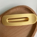 Minimalist bright yellow hollow rectangular hair clip displayed on a wooden tray - Solid Yellow
