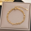 Detailed macro view of triple-layered gold stainless steel bead bracelet with lobster clasp - Gold Triple Layer Bead Style (5165)