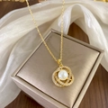 Elegant gold necklace with interlocking zircon rings and white pearl on jewelry box - Gold Camellia Pearl Style