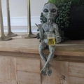 Grey resin alien statue holding a mug with large starry black eyes and stone texture - Grey Alien with Beer