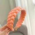 Close-up of vibrant orange braided headband in premium satin silk texture - Orange