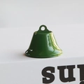 Macro view of a glossy green metal Christmas bell with a top hanging loop ornament - 3.8CM / Green