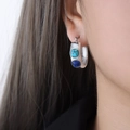 Silver U-shaped twist earrings with inlaid turquoise and lapis lazuli stones on ear - F907 Steel Color Earrings