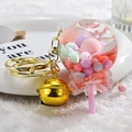 Pink lollipop quicksand keychain with pastel beads, bow, and golden bell charm - Bell Style [Pink]