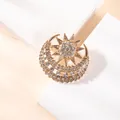 Detailed close-up of a gold star and moon brooch with sparkling cubic zirconia crystals - BZ06-Crescent Octagram Design