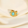 Close-up of vintage gold turquoise ring on elegant beige silk fabric background - Turquoise Blue Gemstone Style (YYR023115-B)