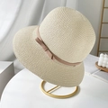 Elegant beige straw sun hat with pink ribbon bow displayed on a modern gold metal stand - M(56-58cm) / Beige