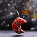 Macro shot of red crescent stone necklace with silver wire wrapped tree of life detail - Red Jasper