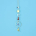 Macro shot of sun catcher with faceted crystal balls and red agate stones on gold chain - Red Agate