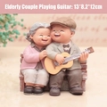 Elderly couple resin figurine of grandpa playing guitar and grandma leaning on bench - Old Couple Figurine / 1041-9 Playing Guitar