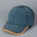 Detailed view of the dark teal crinkle nylon fabric and brown leather edge on the baseball cap - M (56-58cm) / Navy Blue With Brown Piping
