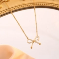 Elegant gold-plated bow pendant necklace with bead chain on a vintage mirror - Bowknot Necklace / Gold