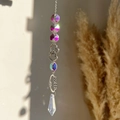 Detail of crystal suncatcher with silver metal hearts and rainbow light prism - Faceted Ball Heart Ring