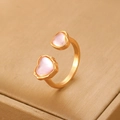 Retro gold heart open ring with asymmetric pink shell stones on a jewelry display - Gold Dual Heart Cat Eye Ring (A-985)